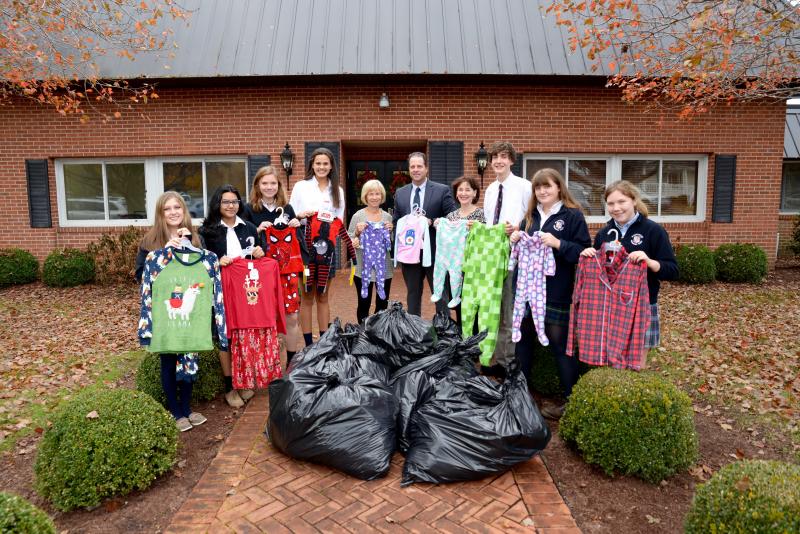 Packing pajama drive donations are (l-r) students Hannah Perdue, Arusa Islam, Kat McCormick and Sami Repass; Pajama Program volunteer Mary Anna Pavlos; Head of Upper School Mike Grosso; WPS English teacher/NHS advisor Kathleen Otway; and students Jacob Meakin, Molly McCormick and Bridget McCormick.